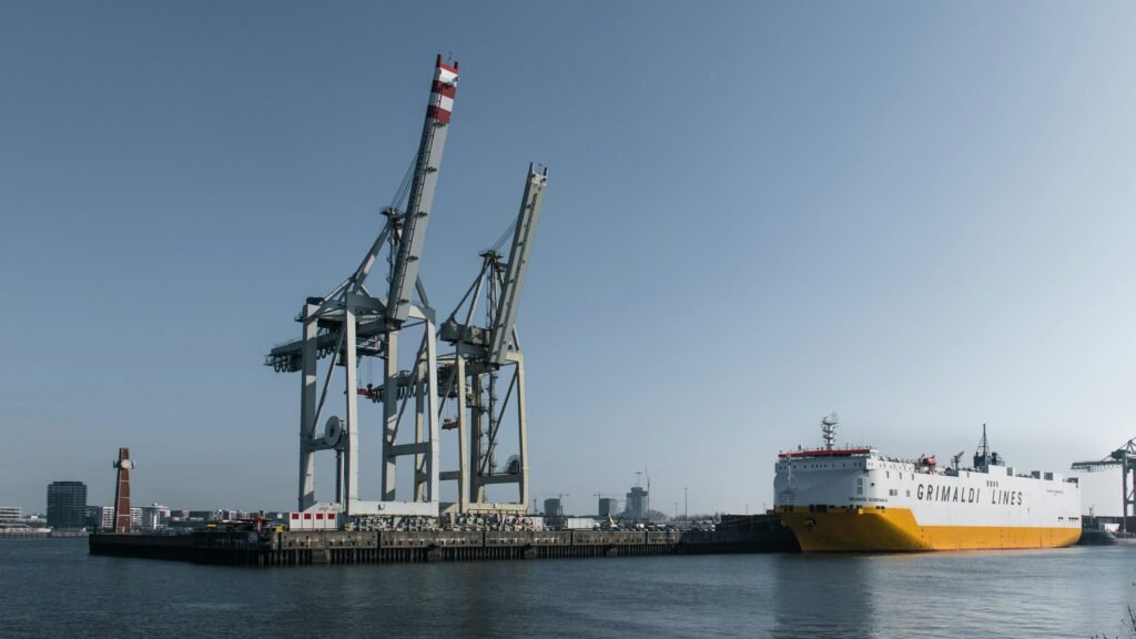 Container ship at a cargo port with cranes