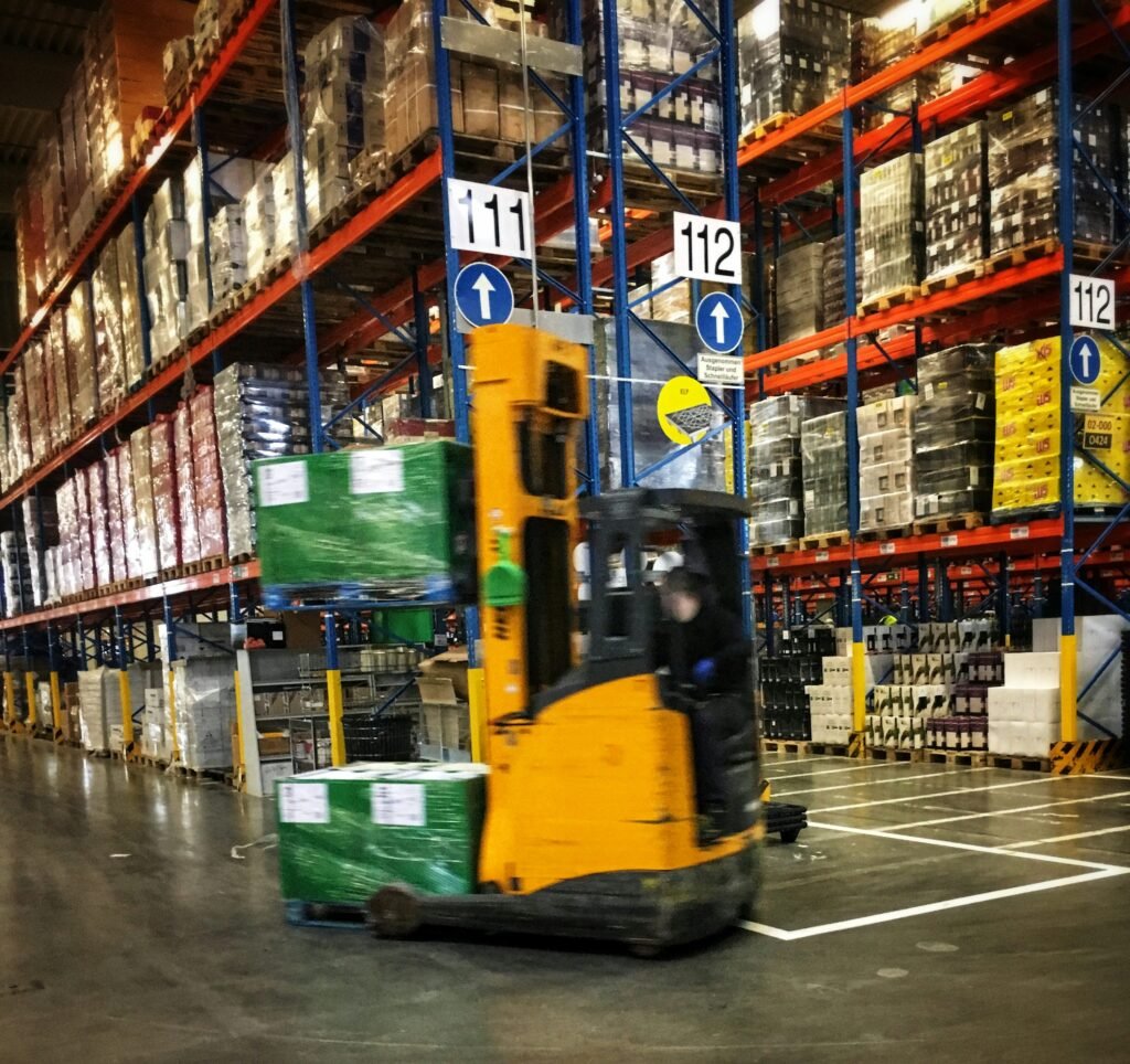 Forklift moving palletized goods through a warehouse